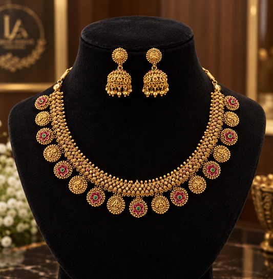 Premium traditional antique gold-plated temple jewelry necklace set featuring intricate coin and floral designs accented with red and green stones product code D418