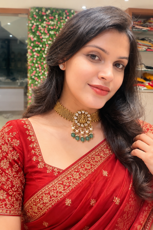 Premium elegant gold-plated mesh choker necklace featuring a central temple-style pendant accented with white stones, delicate pearl clusters, and dangling green beads product code D412