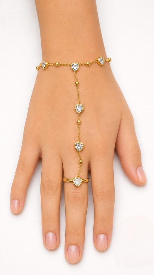 Premium gold-plated heart crystal hand chain featuring a delicate chain connecting a bracelet to a ring with heart-shaped stone accents product code R59