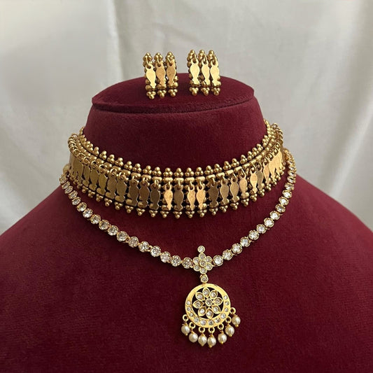 This combo of  vintage-style necklace  and  antique gold-finish  choker set features traditional South Indian Elakkathali leaf motifs and matching 2pair  of  earrings product code T116
