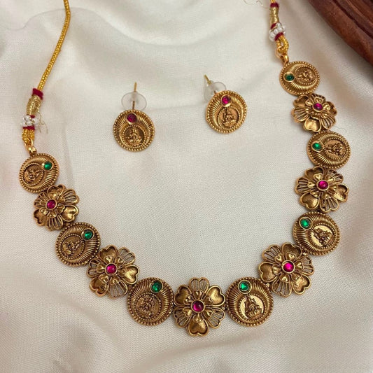 Premium traditional antique gold plated Lakshmi coin floral petaled choker necklace set features intricate goddess motifs accented with ruby and green stones product code T113